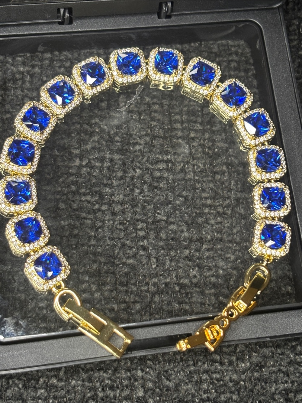 Elegant Gold Tennis Bracelet with Deep Blue Diamonds